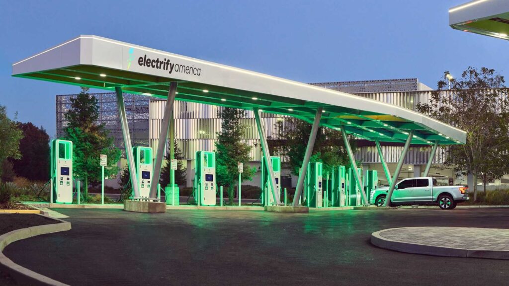 the 2022 ford f 150 lightning electric truck charging at electrify america s 200th charging station in california located at westfield valley fair shopping center in santa clara.
